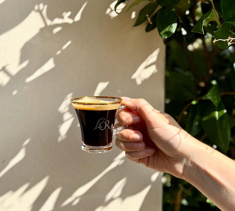 L'OR espresso cup held by a coffee lover