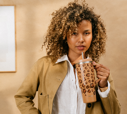 leopard travel cup held by a young woman