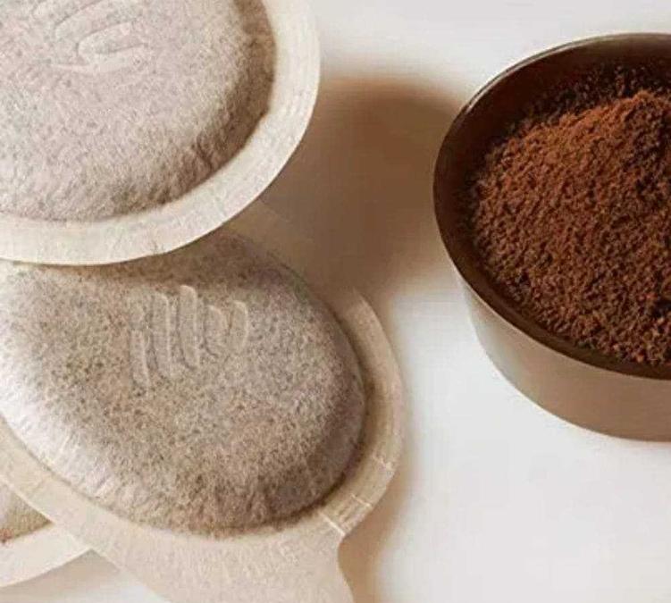 Illy ESE pod with visible logo and ground coffee alongside