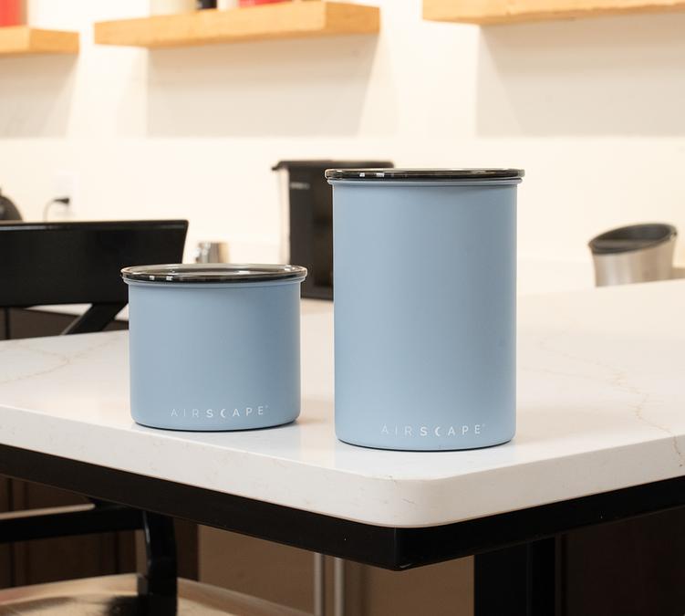 two blue metal airscape coffee storage canisters