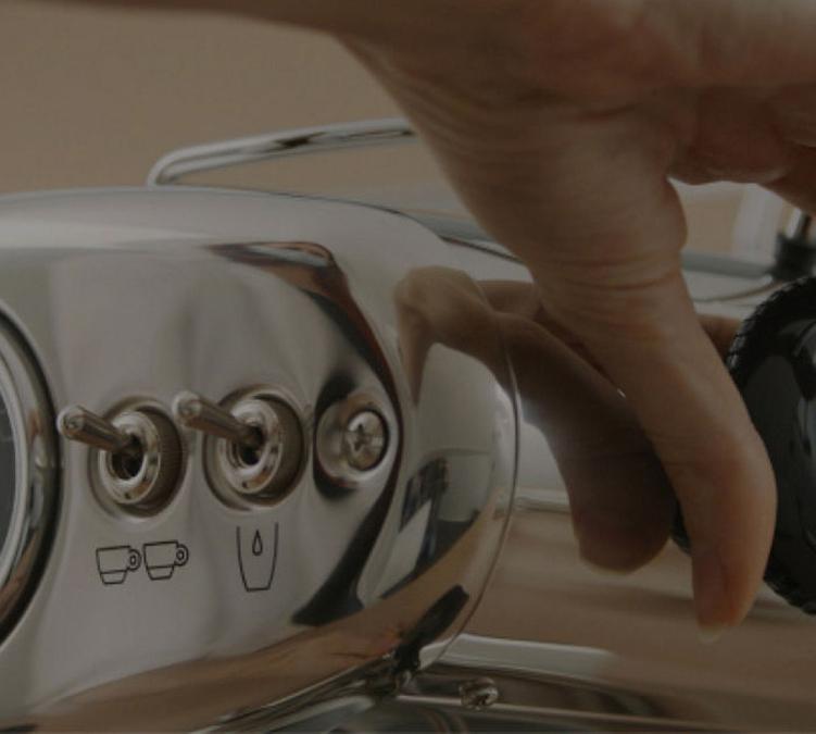 manual espresso machine extracting coffee with an Illy ESE pod