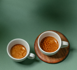 two espresso cups with a smooth, golden crema